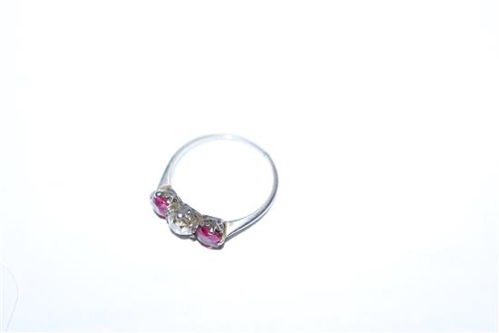 A white metal, ruby and diamond three stone ring, (shank cut).